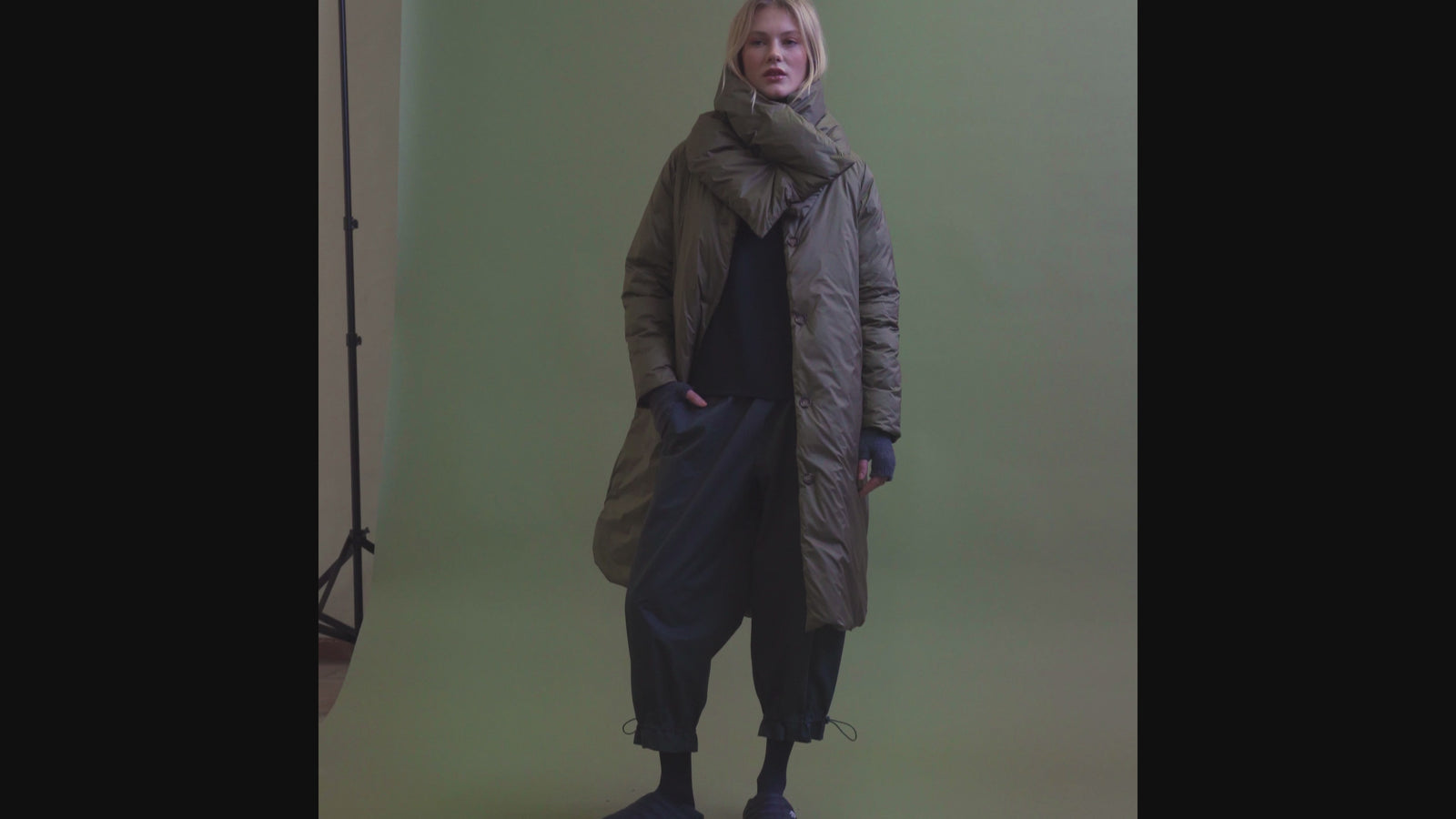 Video showcasing multiple coats in a studio-style FW25 editorial shoot, featuring structured silhouettes, textured fabrics, and contemporary styling on models walking and posing against a neutral background.