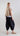 Back view of Psophía SS26 women’s wide-leg balloon pants in Black, combining minimalist design with everyday comfort.